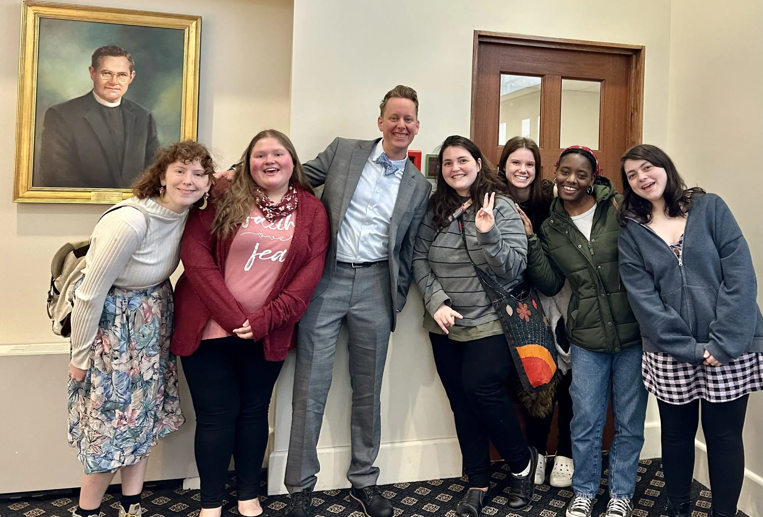 Campus Minister Russ Kerr with Students posing for a group photo at Grace & Holy Trinity Church.