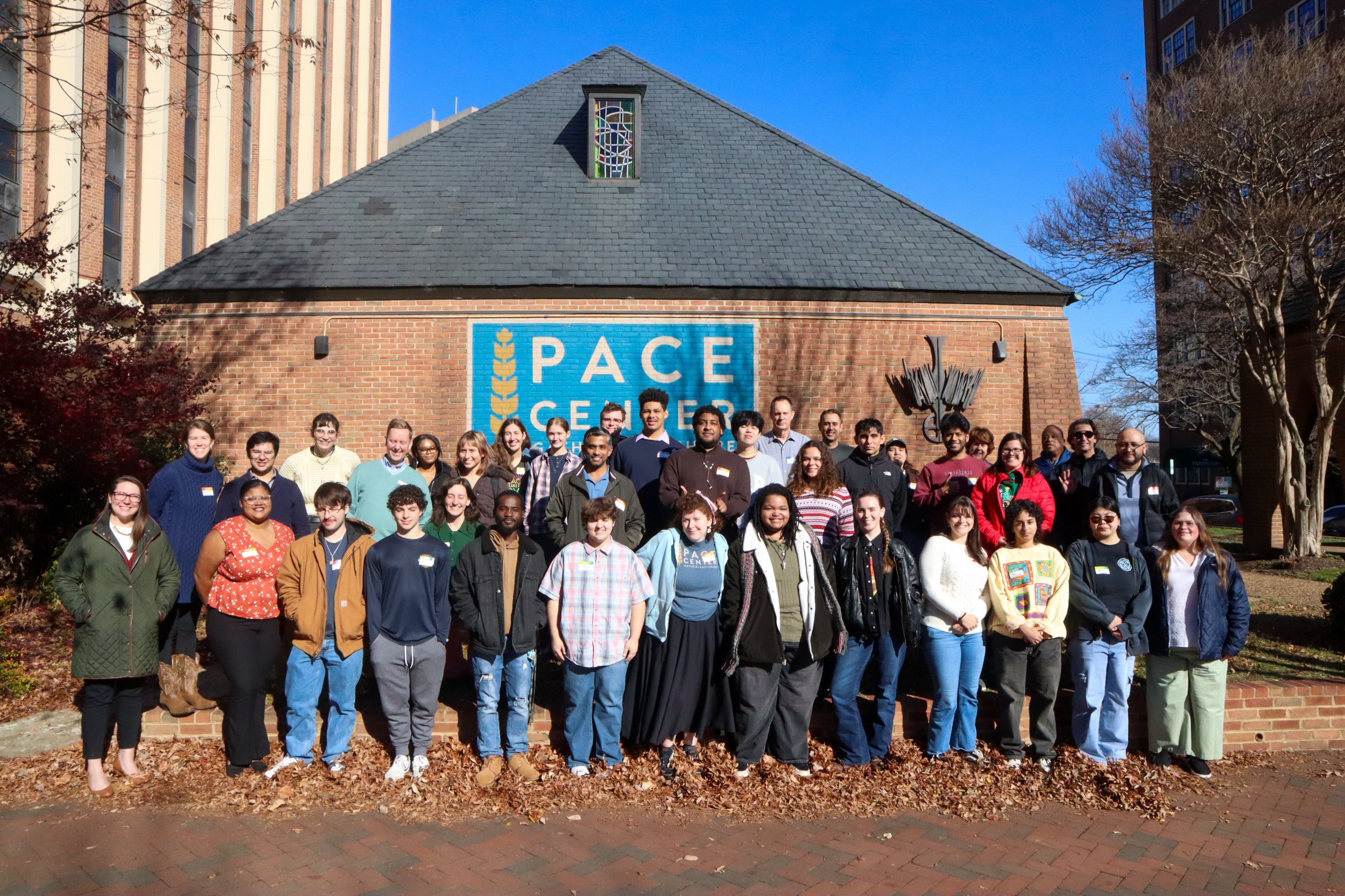 The facade of The Pace Center's brick building boasting a large blue Pace Center logo in the center.